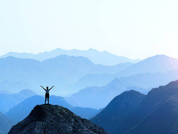 woman at the top of mountain photo